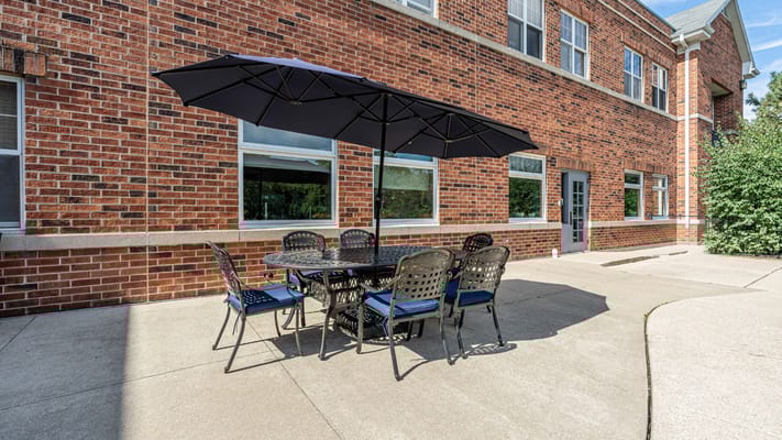 Outdoor seating area with an umbrella and tables