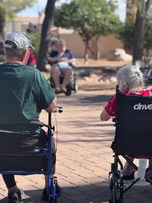 Residents enjoying time outdoors in wheelchairs
