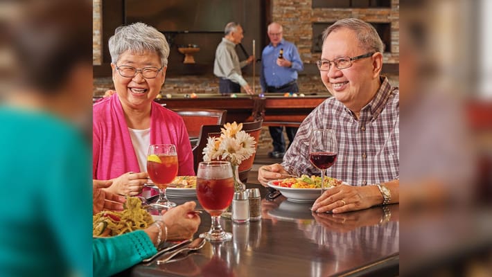 Residents enjoying a meal together in the dining room