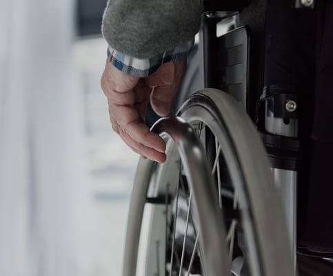Close-up of a hand on a wheelchair wheel