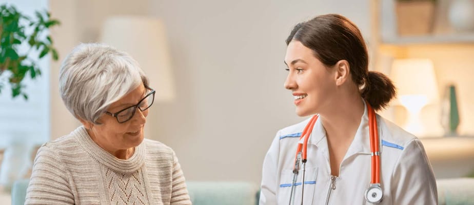 Nurse engaging with elderly resident in a cozy room