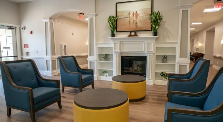 Bright common area with comfortable seating and a fireplace