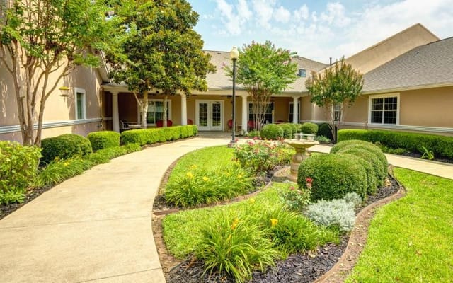 Lush garden path leading to a common area