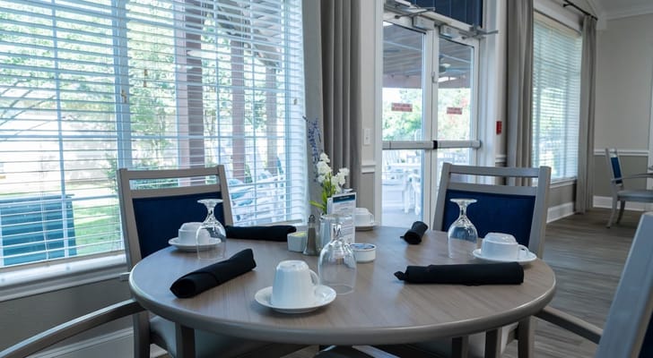 Dining table set for a meal in a bright dining area