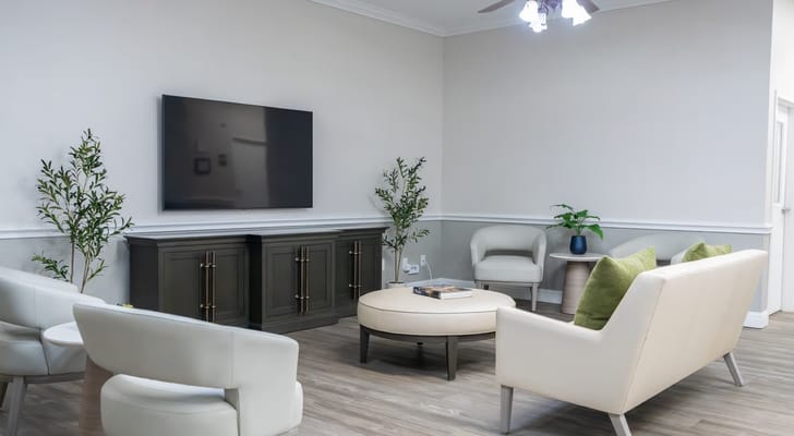 Bright interior common area with seating and TV