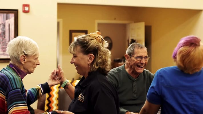 Residents and staff engaging in an activity together