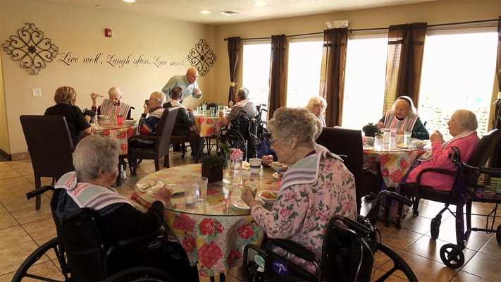 Residents enjoying a meal in the dining room