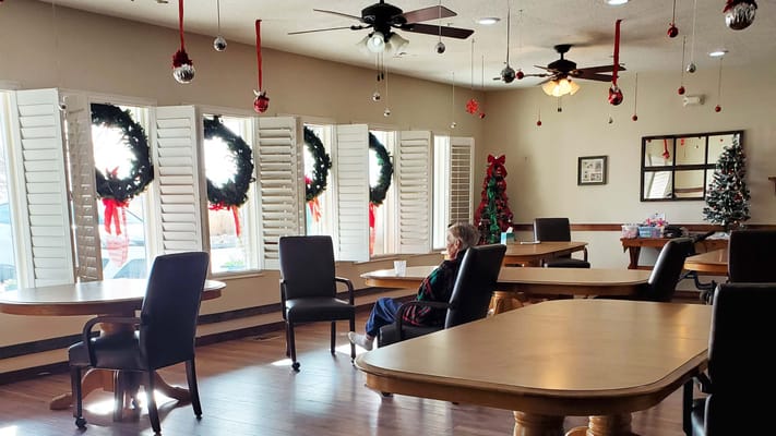 Common area decorated for the holidays with a resident