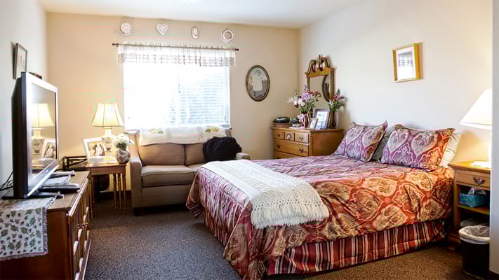 Cozy resident room with a bed and couch