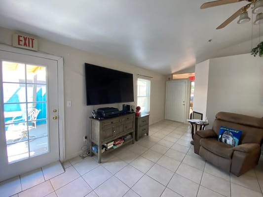 Common area with a comfortable chair and TV