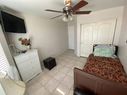 Private resident room with a bed and TV