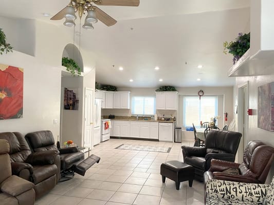 Interior common area with seating and kitchen backdrop