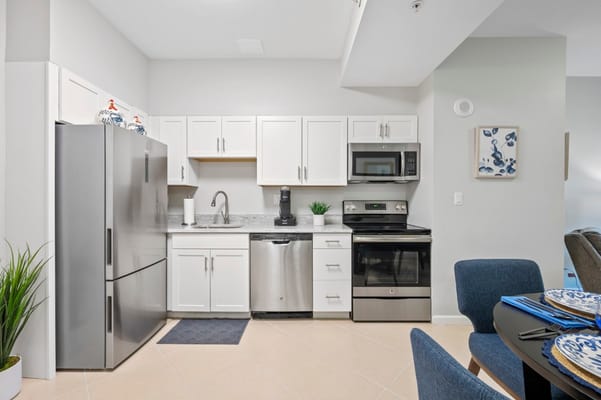 A modern kitchen with stainless steel appliances and granite countertops