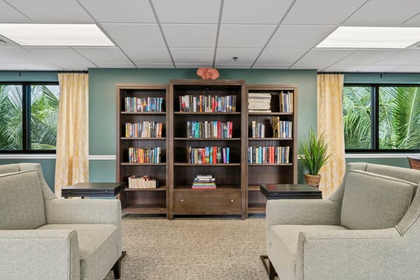 Cozy library lounge with bookshelves and comfortable seating