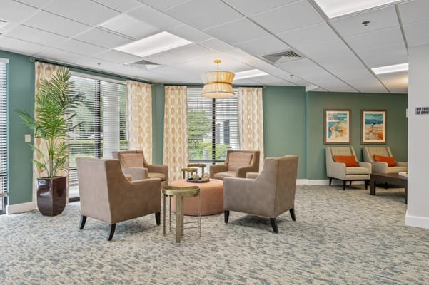 Spacious lounge area with seating and large windows