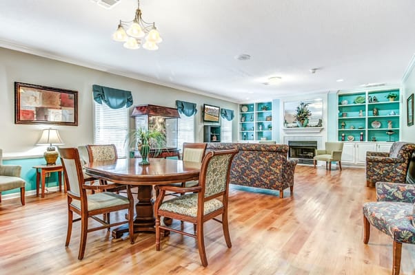 Bright common area with seating and a fireplace