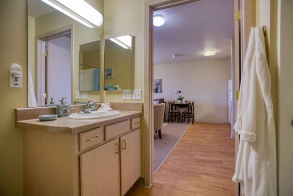 Brightly lit bathroom with a vanity and sink