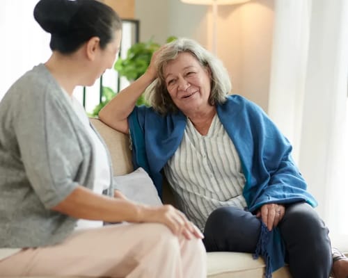 A caregiver and resident enjoying a conversation.