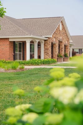 Exterior view of a senior living facility surrounded by greenery