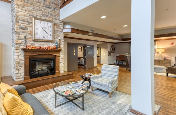 Common area with seating around a fireplace