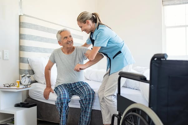 A caregiver assisting a senior resident in a bedroom