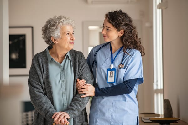 Caregiver assisting a senior resident indoors