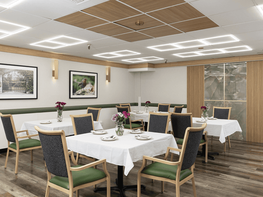 Bright dining room with tables set for meals