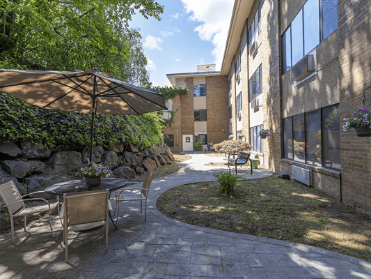 Outdoor seating area with plants and a pathway