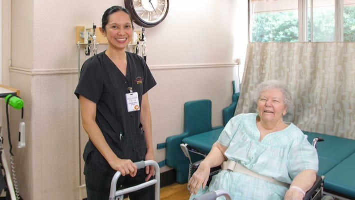 Staff member assisting a resident in a care setting