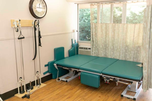 Therapy room with treatment table and equipment