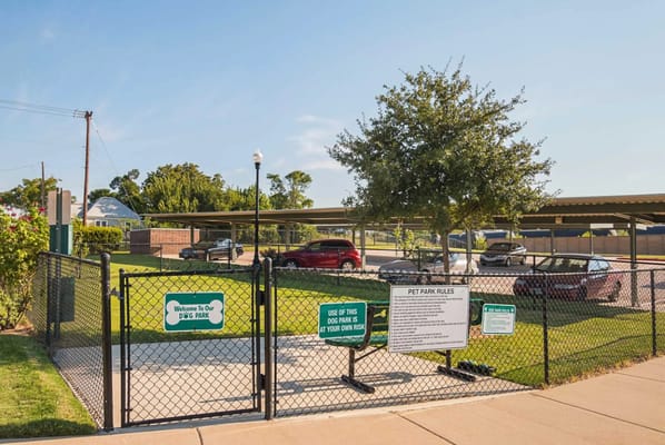 Entrance to a pet park with rules and signage