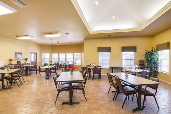 Bright dining room with tables and flowers