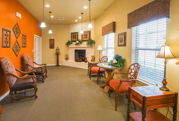 Bright common area with seating and fireplace