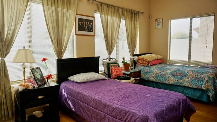 Cozy resident room with two beds and natural light
