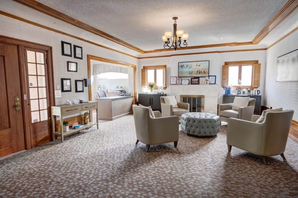 Cozy living room with seating and a fireplace at Crescent Landing.
