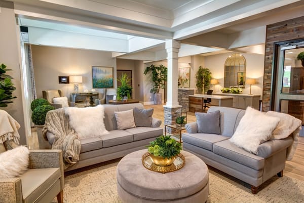 Stylish living room with two sofas, plants, and a coffee table