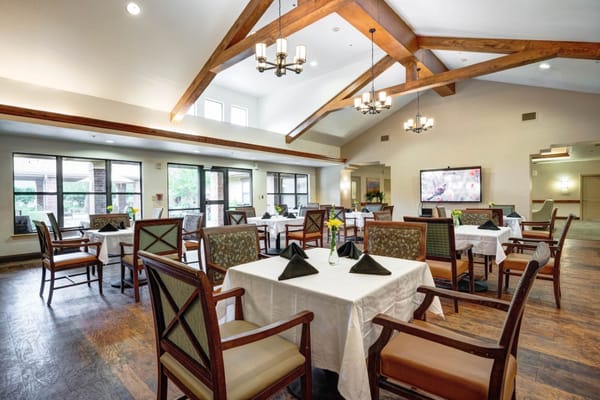 Bright dining area with tables and chairs in Oak Hills Terrace Memory Care