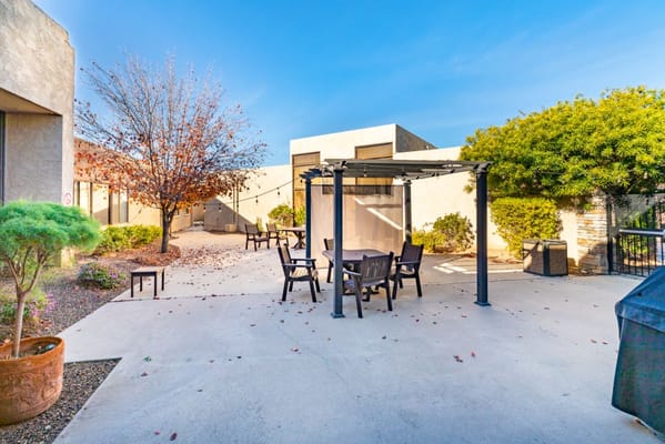 Outdoor seating area with a pergola and landscaping