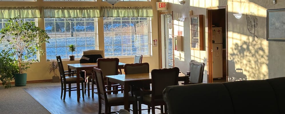 Bright common area with large windows and seating