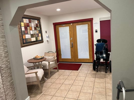 A cozy lobby area with seating and a wheelchair
