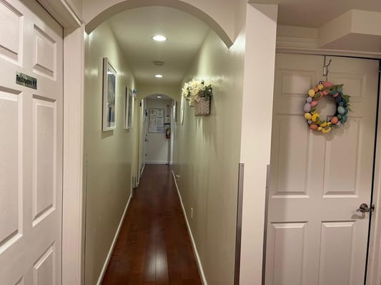 Brightly lit hallway with room doors and decorations