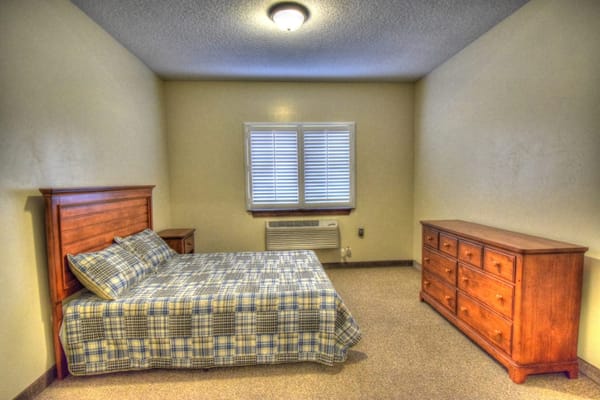 Private resident room with a bed and dresser