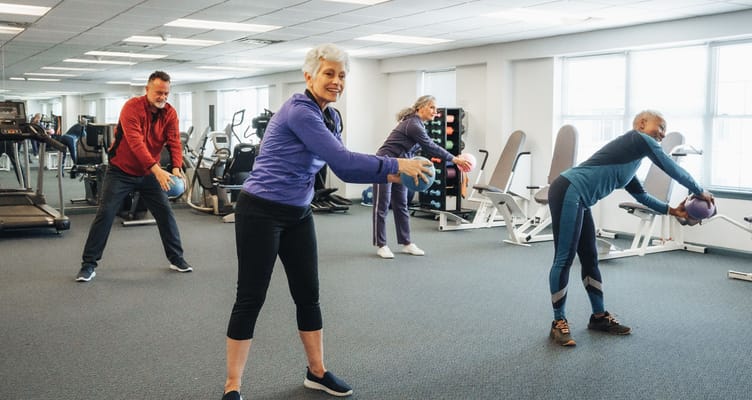 Residents participating in a fitness class in the gym