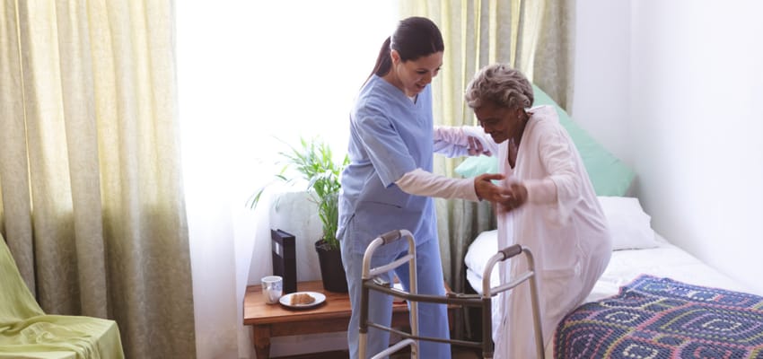 Caregiver assisting resident in their room