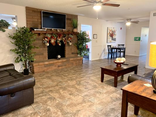 Spacious living room with a fireplace, seating area, and dining table.