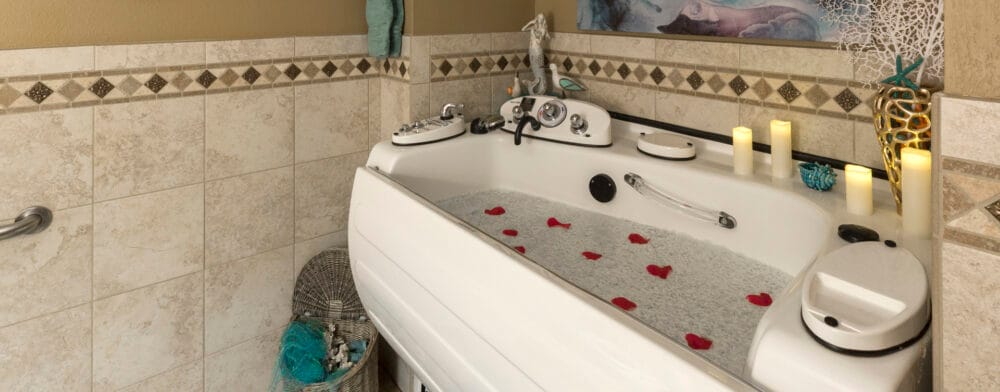 A relaxing spa tub with rose petals and candles