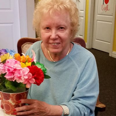 Resident holding a colorful bouquet of flowers