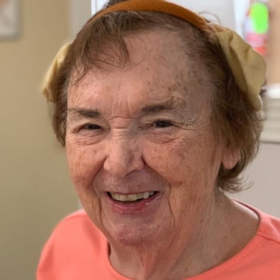 A smiling resident in an activity room