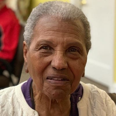 Close-up of an elderly resident smiling indoors
