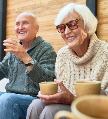 Seniors enjoying a warm beverage in a cozy setting